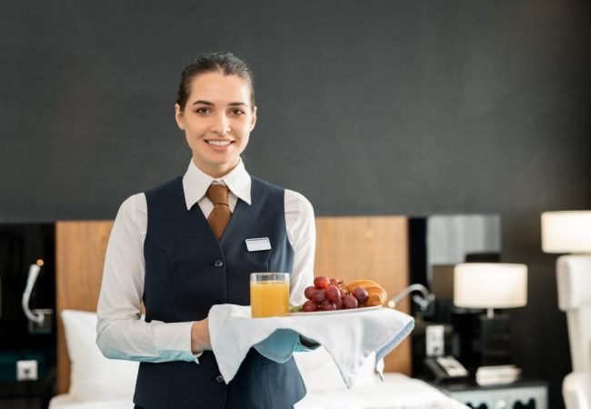 young-smiling-hotel-staff-holding-tray-with-breakfast.jpg young-smiling-hotel-staff-holding-tray-with-breakfast.jpg